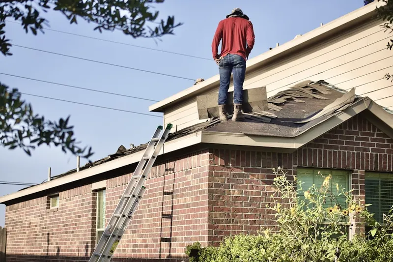 Professional roofer working on a residential roof in Sagamore